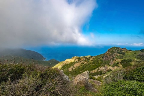 Sardinia, Mountainous coastal landscape by the sea, blue sky with clouds, Bosa, Europe, Province of