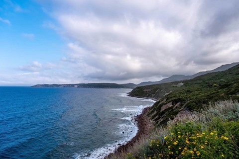 Sardinia, mountains, sea and coast, coastal landscape and blue sky with clouds, Villanova