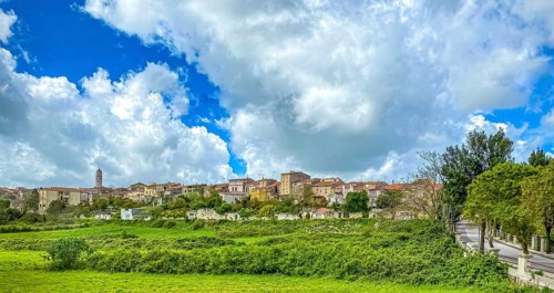 Sardinia, town view, town wall and church tower of Thiesi, blue sky with clouds, Thiesi, Europe,