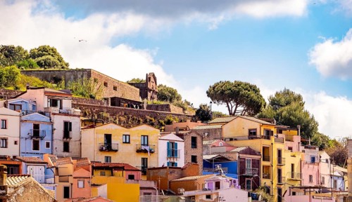 Sardinia, picturesque view of Bosa with pavilions on the promenade, residential buildings and