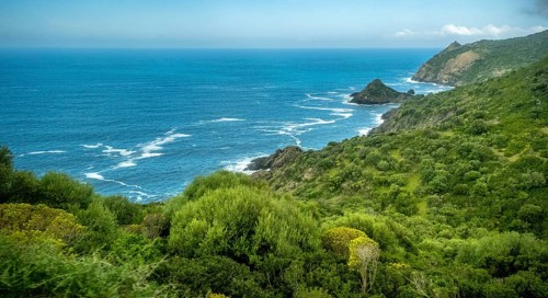 Sardinia, Mountainous coastal landscape by the sea, blue sky with clouds, Bosa, Europe, Province of
