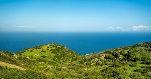 Sardinia, Mountainous coastal landscape by the sea, blue sky with clouds, Bosa, Europe, Province of