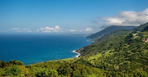 Sardinia, Mountainous coastal landscape by the sea, blue sky with clouds, Bosa, Europe, Province of
