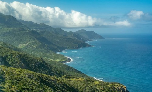 Sardinia, Mountainous coastal landscape by the sea, blue sky with clouds, Villanova Monteleone,