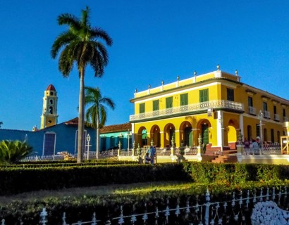 Centre of Trinidad Palacio Brunet, yellow palace with blue sky and the church Convento de San