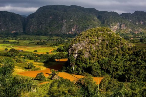 Farmhouse, farm cottage, barn for drying tobacco leaves, tobacco fields and the mountains of the