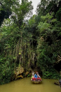 Exit of the cave system, tourists in an electric boat with life jackets, caves of the Indios, Cueva