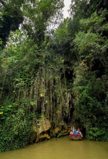 Exit of the cave system, tourists in an electric boat with life jackets, caves of the Indios, Cueva