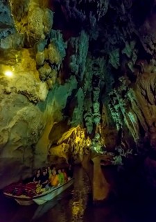 Tourists in a boat on the underground rivers in the caves of the Indios, Cueva del Indio,