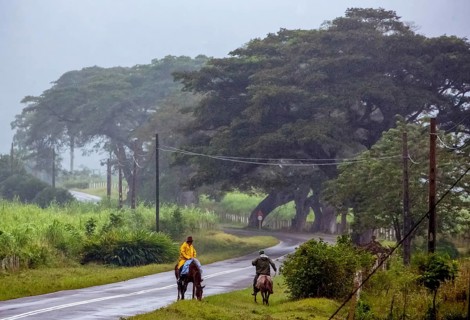 Rider on the rainy country road in Vinales, Viñales, Cuba, Pinar del Río