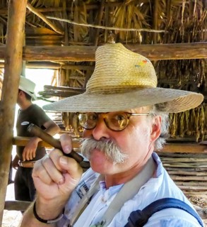 Hans Blossey Tourist smokes a Havana cigar, tobacco farm in the Vinalestal, Viñales, Cuba, Pinar