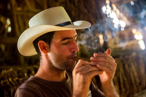 Tobacco farmer, tobacco farmer Luis Manne Alvares Rodrigues lights a Havana cigar, tobacco farm in