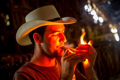 Tobacco farmer, tobacco farmer Luis Manne Alvares Rodrigues lights a Havana cigar, tobacco farm in