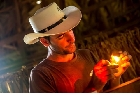 Tobacco farmer, tobacco farmer Luis Manne Alvares Rodrigues lights a Havana cigar, tobacco farm in