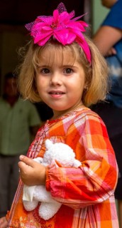 Little Cuban girl with white teddy bear and pink bow in her hair, Pink bow, Viñales, Cuba, Pinar