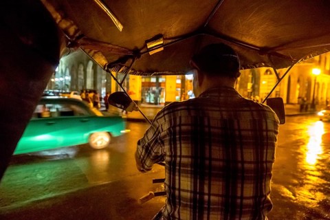 Rickshaw driver on a night ride through Havana, Havana, La Habana, Cuba, Cuba, Central America