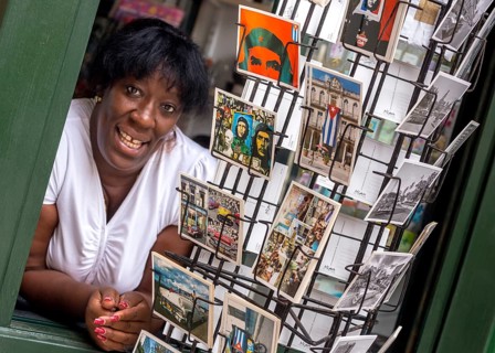 Kiosk saleswoman, Cuban, postcard stand with postcards of Ernesto Che Guevara, La Habana, Cuba,