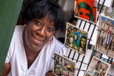 Kiosk saleswoman, Cuban, postcard stand with postcards of Ernesto Che Guevara, La Habana, Cuba,