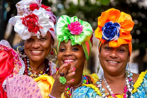 Three Cuban beauties on the streets of Old Havana in their colourful Spanish-inspired costumes, La