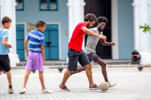 Cuban youths playing football in the marketplace, La Habana, Cuba, Caribbean, Central America,