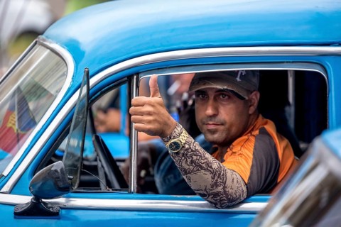 Taxi driver, blue vintage car in street scene, old American street cruiser on the streets of
