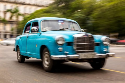 Speed, blurred, driving old car, blue Mercedes vintage car in street scene, old American road