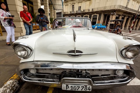 Radiator grille, white vintage car in street scene, Oldsmobile, Old American road cruiser on the