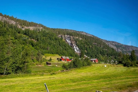 Red mountain huts, meadows, trees, waterfall, mountains, blue sky, Skulestadmo, Hordaland, Norway,