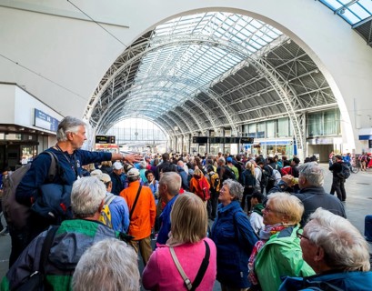 Tourists at Bergen railway station, tour guide, glass dome roof, train, Bergen, Hordaland, Norway,
