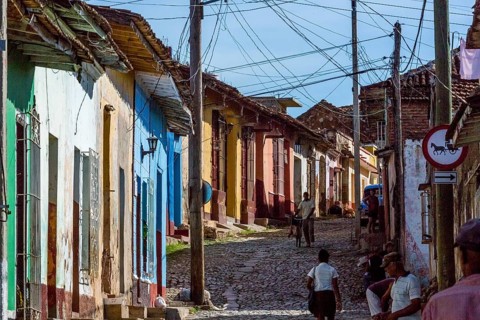 Street scene in Trinidad with cobbled street and terraced houses, electrical installations,