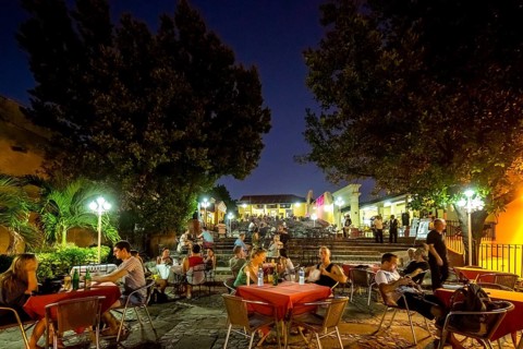 Restaurant and pub in the old town of Trinidad with visitors at the blue hour, tourists at tables,