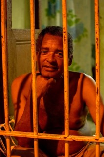 Paid car guards behind their barred windows in the old town of Trinidad, Street scene in the old