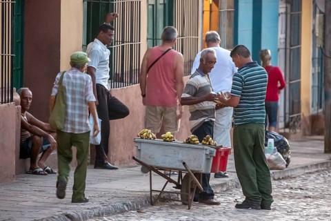 Banana vendor with his stall on the street, Street scene in the old town of Trinidad, Trinidad,