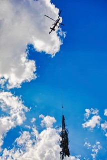 Helicopter transports tree under cloudy sky, transport helicopter, timber transport, Saas Grund,