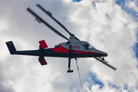 Aerial view of a helicopter with clouds in the background, transport helicopter, timber transport,
