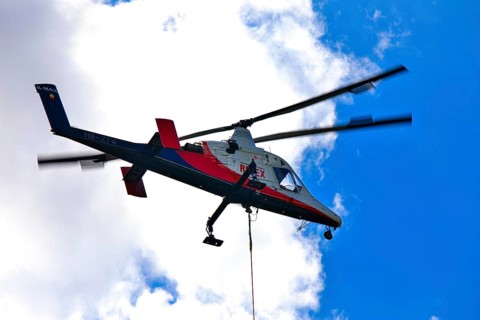 Helicopter in flight in the blue sky, transport helicopter, timber transport, Saas Grund, Canton