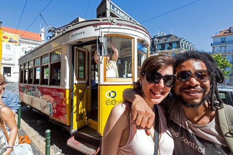Portuguese tourist couple in front of tram 28, Lisbon, Lisbon district, Portugal