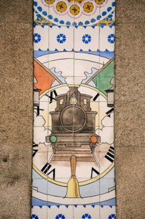 Azulejos tiles depict a steam locomotive with clock, Sao Bento railway station, Oporto, Porto