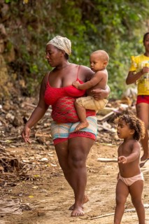 Mother with two children barefoot at a rubbish dump, poverty on the island of Cuba, Trinidad, Cuba,