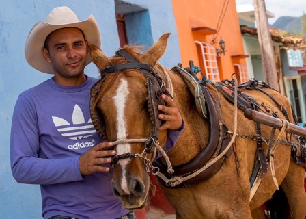 Cuban rider cowboy with his horse in the streets of Trinidad, Trinidad, Cuba, Sancti Spíritus,