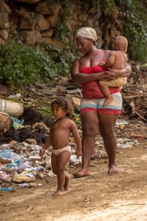 Mother with two children barefoot at a rubbish dump, poverty on the island of Cuba, Trinidad, Cuba,