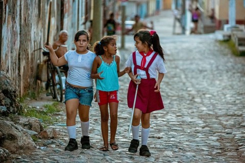 Three girls discussing on the street, Schoolgirls, Children, Street scene in the old town of