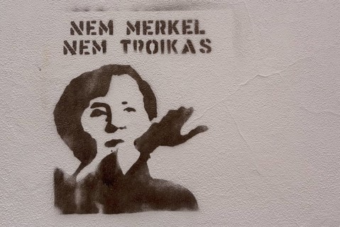 Protest Gafitti against Merkel and Troika with raised arm and Hitler salute, Political protest in