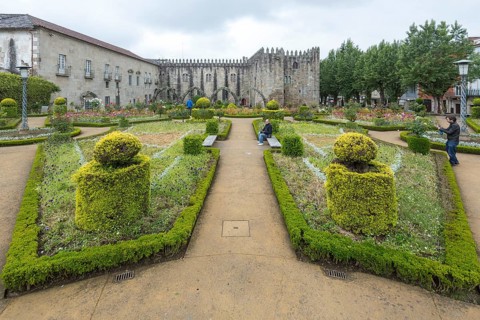 Jardim de Santa Barbara borders the crenellated facade of Antigo Paco Episcopal, former