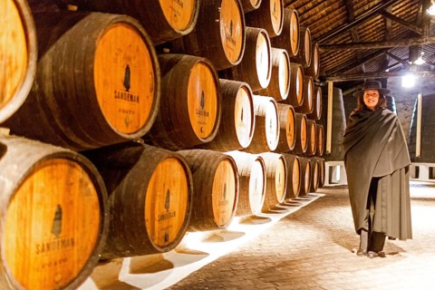 Classic travel guide with student robe, zorro hat and cape, port wine barrels, wine cellar of the
