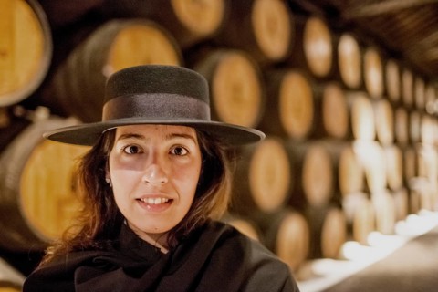 Classic travel guide with student robe, zorro hat and cape, port wine barrels, wine cellar of the