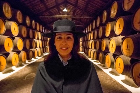 Classic travel guide with student robe, zorro hat and cape, port wine barrels, wine cellar of the