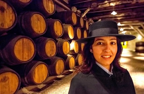 Classic travel guide with student robe, zorro hat and cape, port wine barrels, wine cellar of the