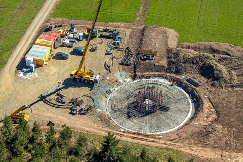Aerial view, construction site with construction crane for wind turbine wind power plant at