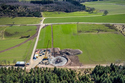 Aerial view, construction site with construction crane for wind turbine wind power plant at
